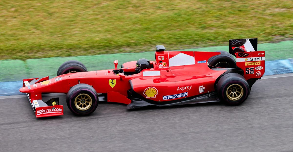 High-speed Formula 1 car in action on an outdoor racing track showcasing motion and excitement