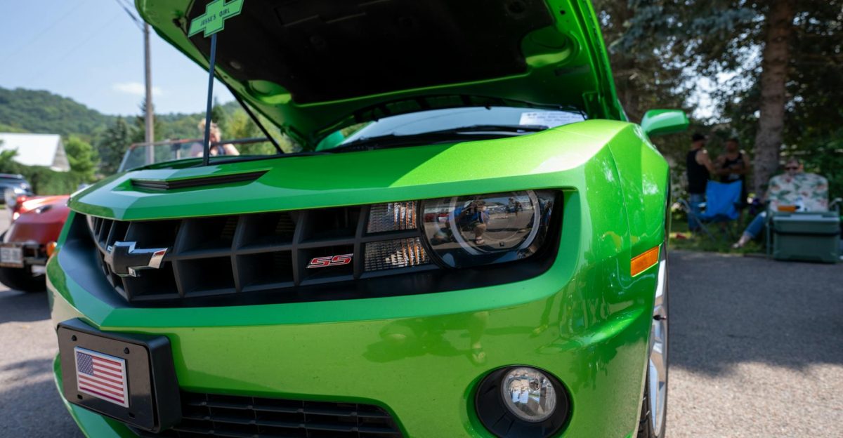 A vibrant green Chevrolet Camaro with the hood open at a car show in Nelson Wisconsin