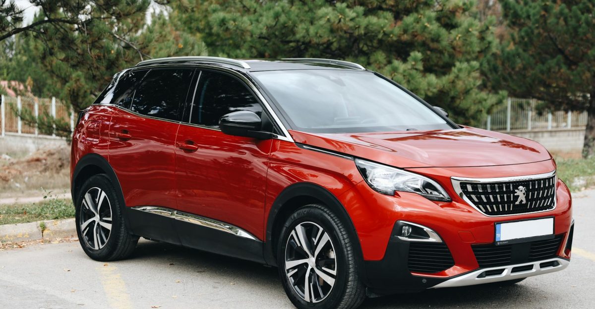 Stylish red SUV parked outdoors in Sivas T rkiye with trees and clear sky