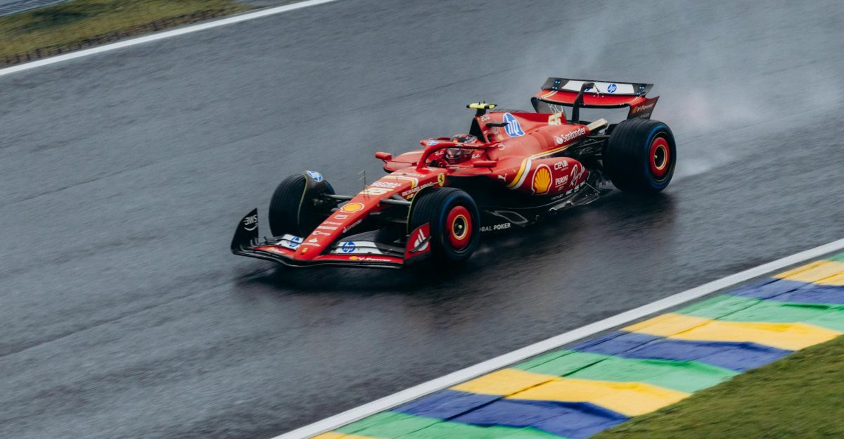 Ferrari Formula 1 car speeding through a wet track at Interlagos capturing dynamic racing action