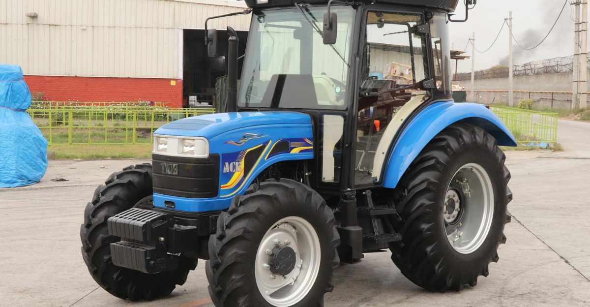 A powerful blue 4WD tractor parked outdoors in an industrial area showcasing modern agricultural equipment in India