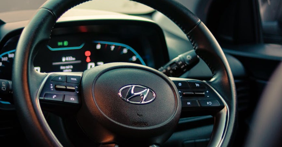 Close-up of a Hyundai steering wheel inside a car showcasing the modern dashboard design
