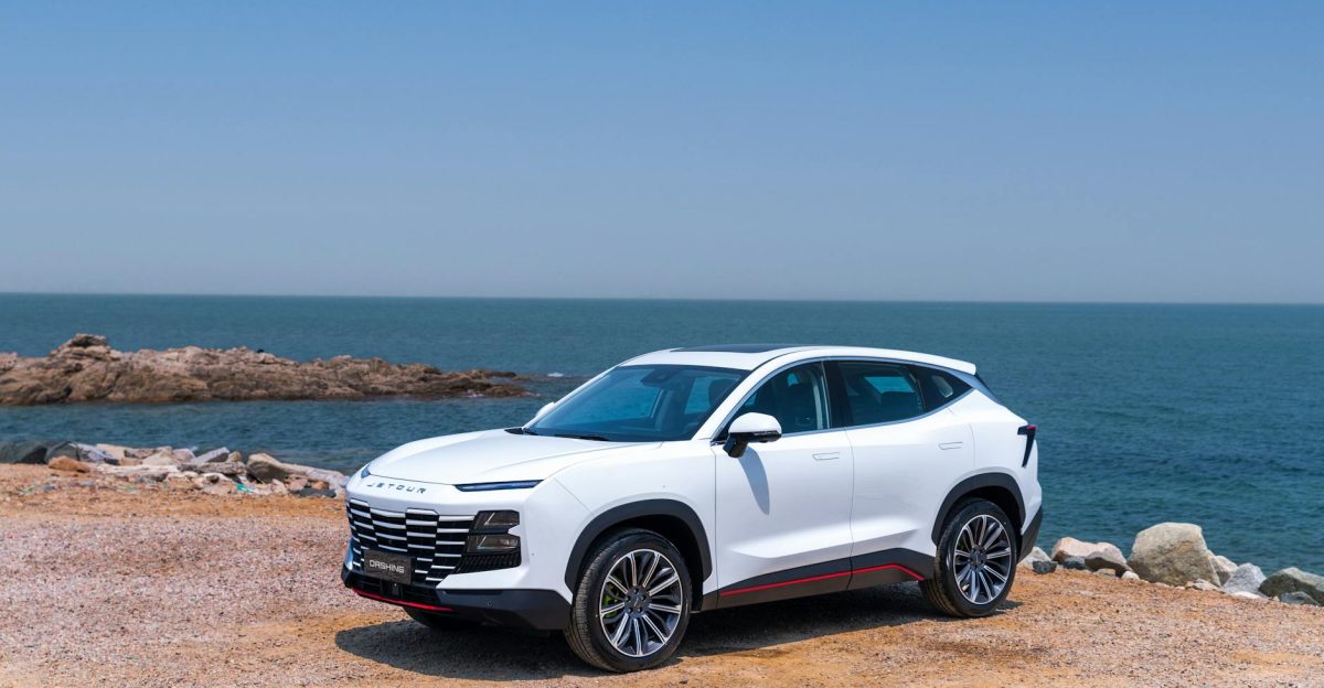 Elegant white SUV parked by the sea on a clear sunny day perfect for coastal adventures