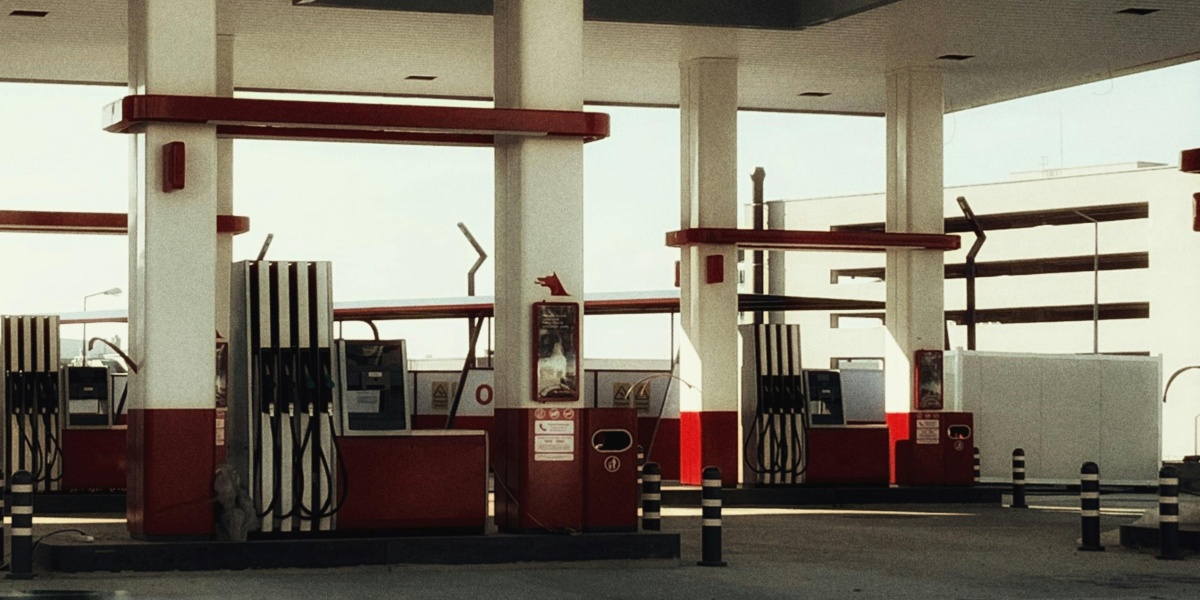 Brightly lit modern gas station featuring multiple fuel pumps and a distinct red and white design.