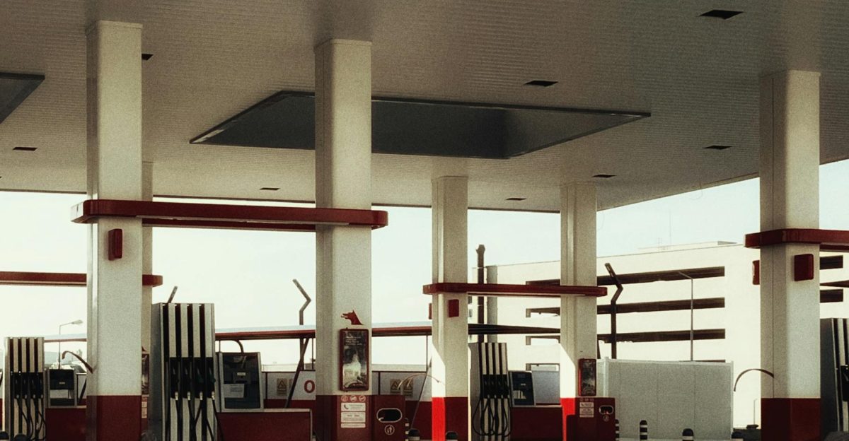 Brightly lit modern gas station featuring multiple fuel pumps and a distinct red and white design