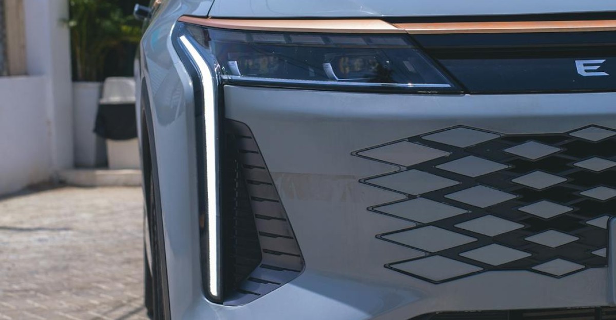 Front view of a modern electric car parked outdoors in daylight showcasing sleek design