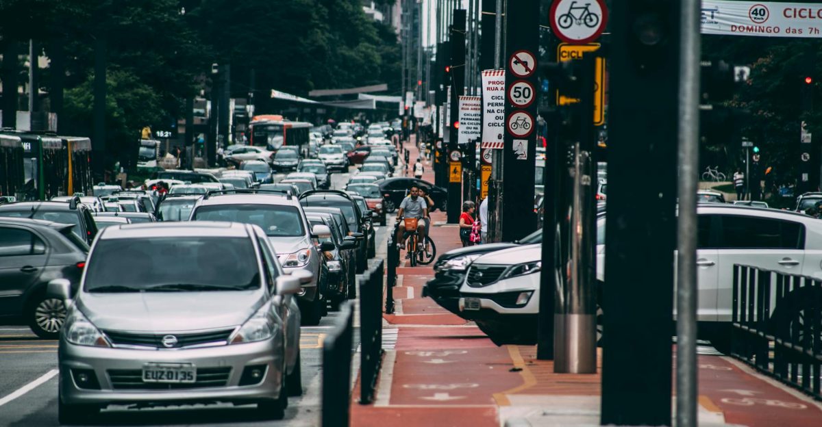 Urban street scene with heavy traffic and cyclists in a bustling city environment