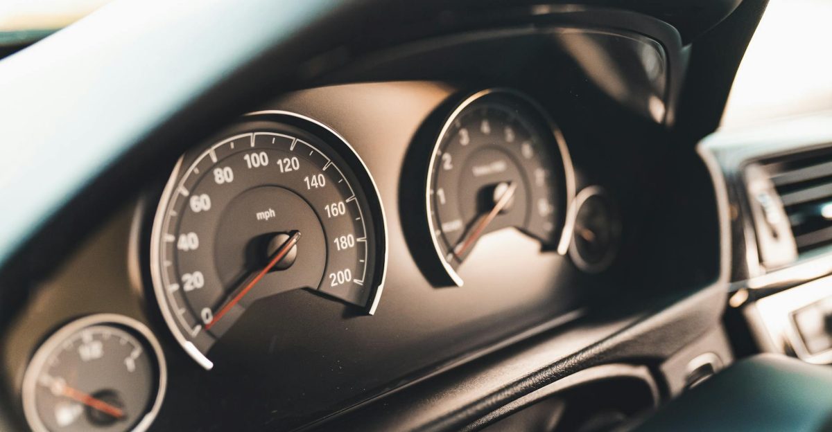 Detailed view of a car dashboard featuring speedometer gauges ideal for automotive themes