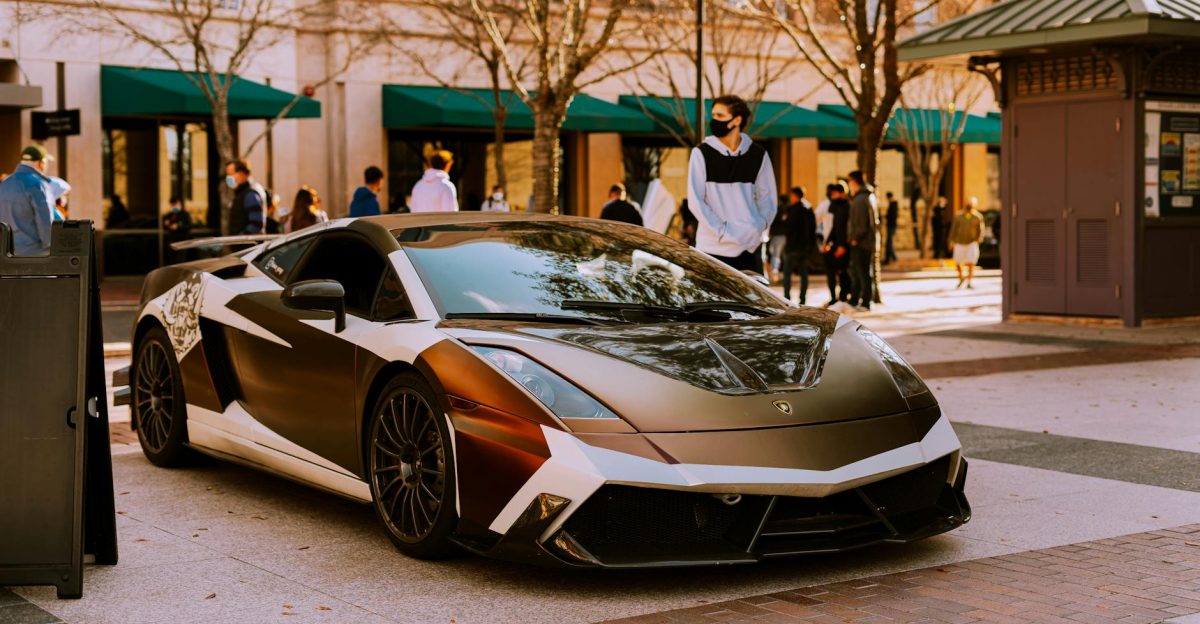 Sleek Lamborghini Gallardo parked outdoors with people in background urban setting