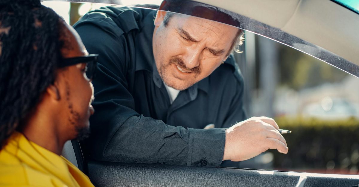 A police officer interacts with a driver through a car window emphasizing law enforcement and public safety