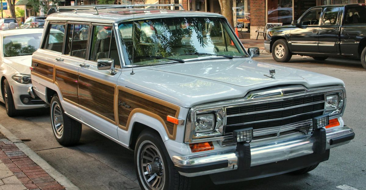 Classic Jeep Wagoneer with wood paneling parked on an urban street reflecting a vintage aesthetic