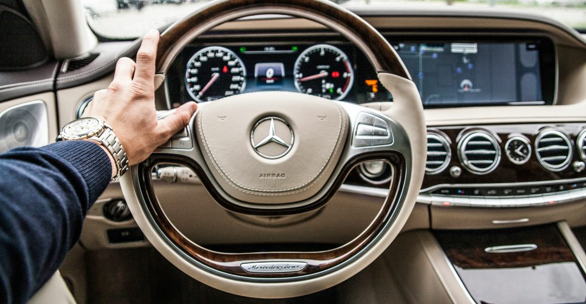 person sitting in Mercedes-Benz driver seat