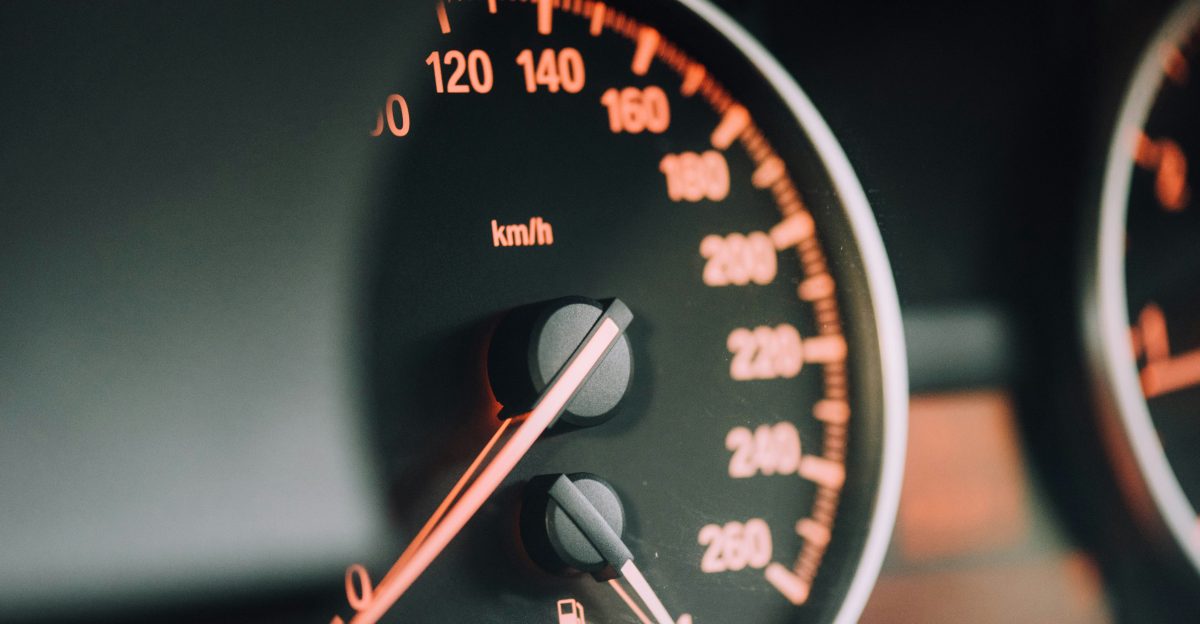 closeup photo of black analog speedometer