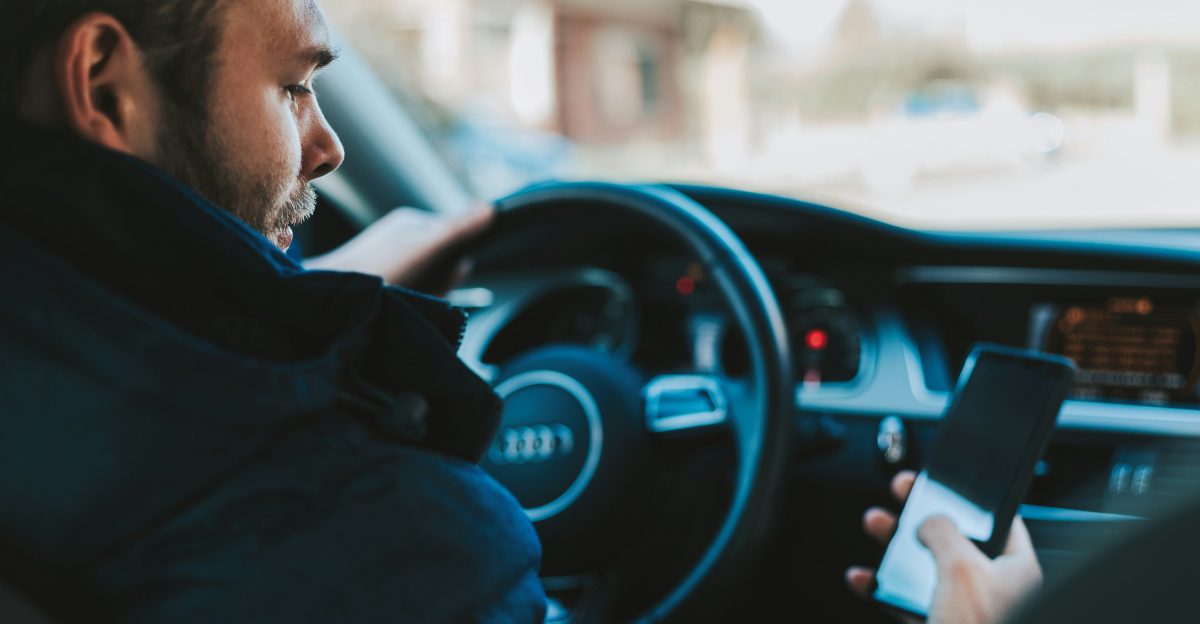 man holding black smartphone
