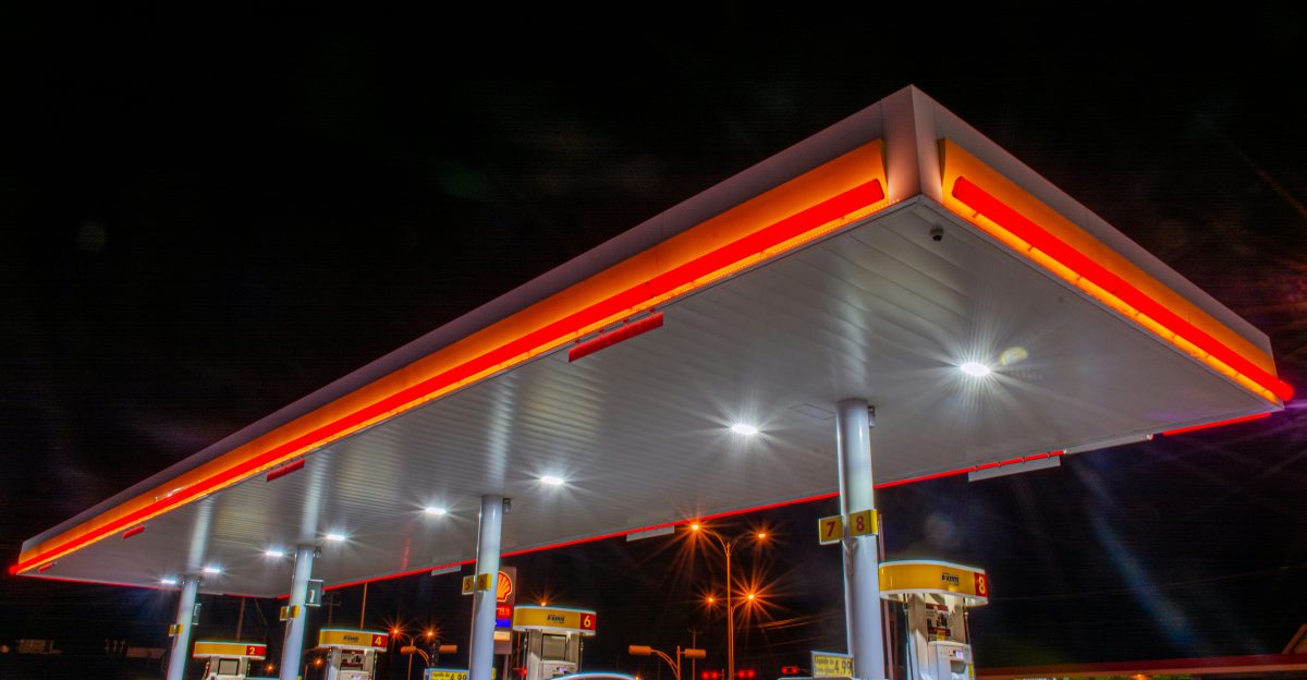 white car parked in front of red and white building during night time