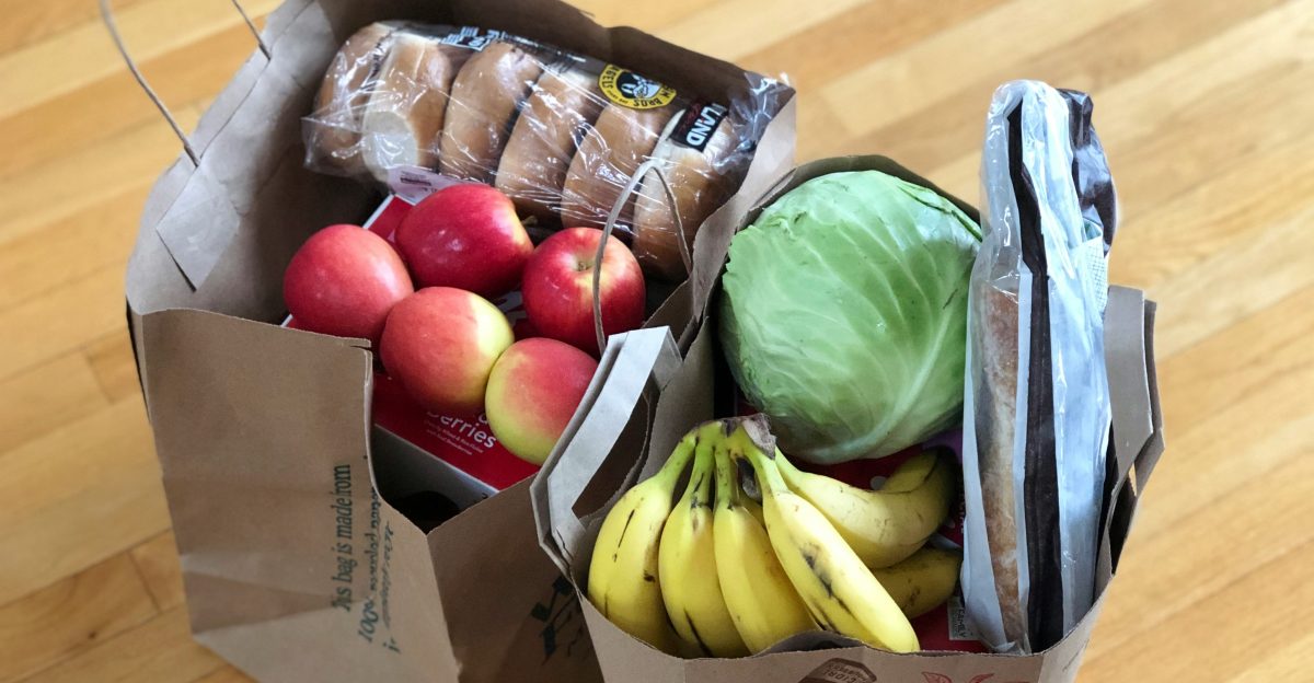 apples and bananas in brown cardboard box