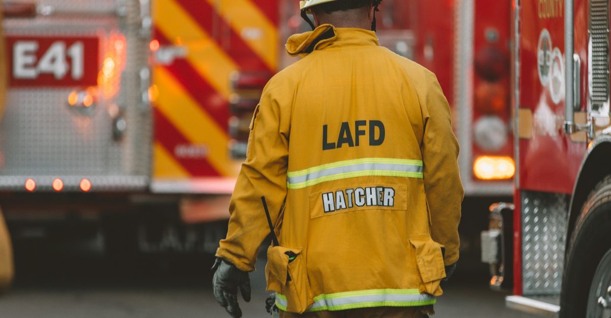 man in yellow jacket and brown pants walking on street during daytime