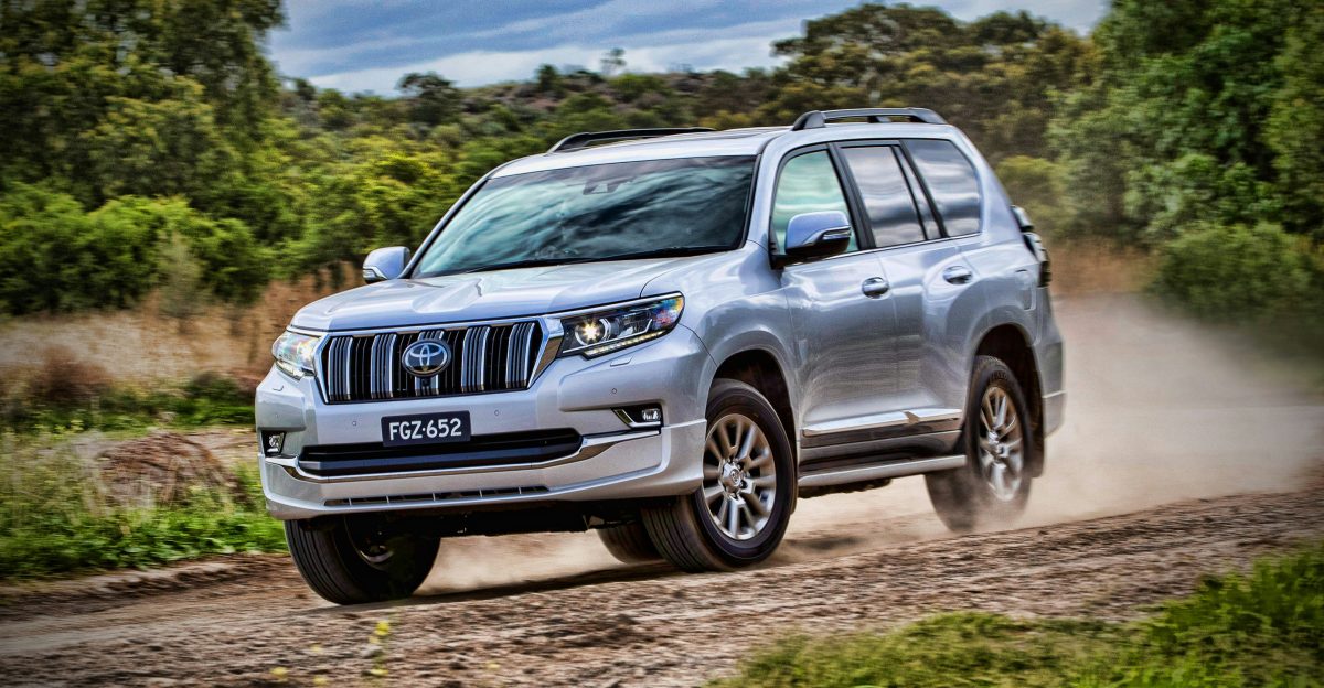 gray mercedes benz suv on brown dirt road during daytime
