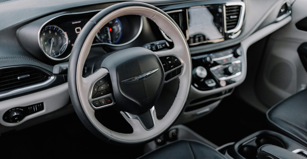 the interior of a car with a steering wheel and dashboard