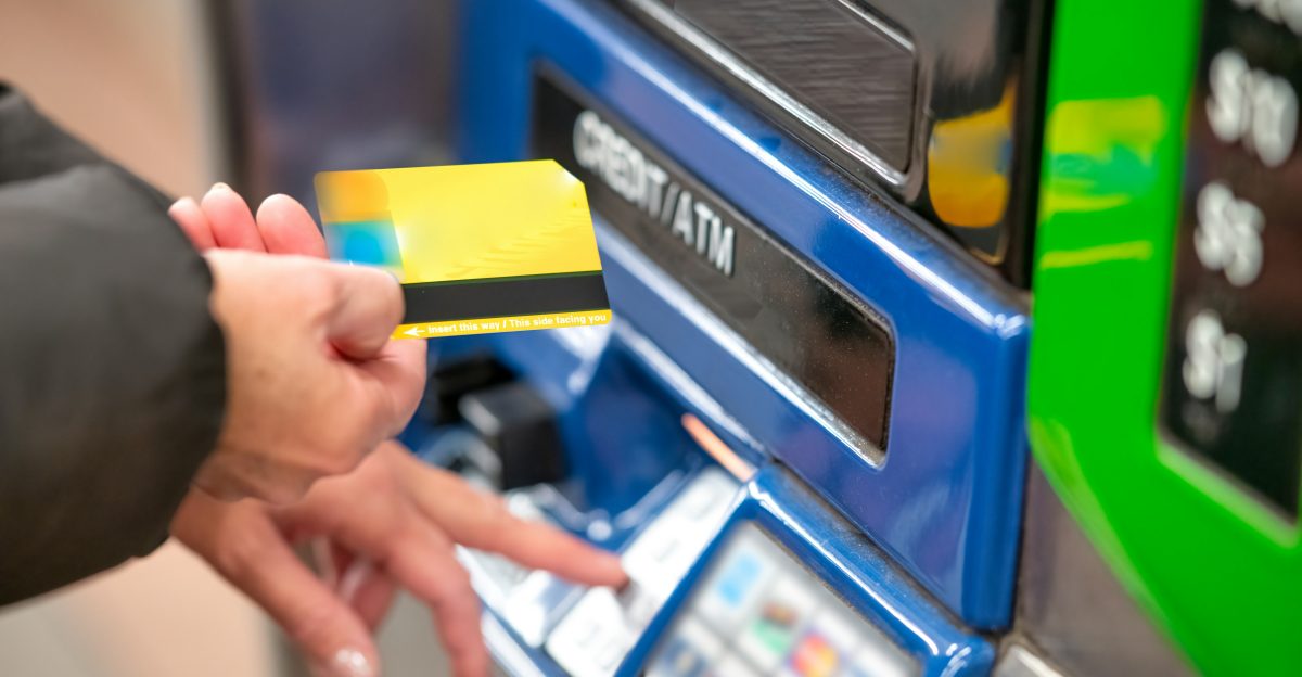 a person using a credit card to pay for a machine