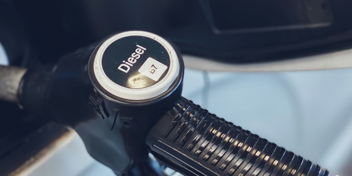 a close up of a gas pump with a car in the background