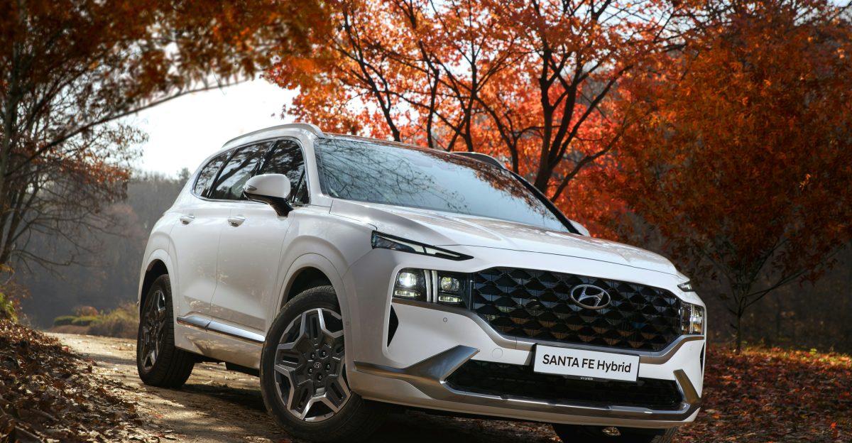 a white suv driving down a dirt road