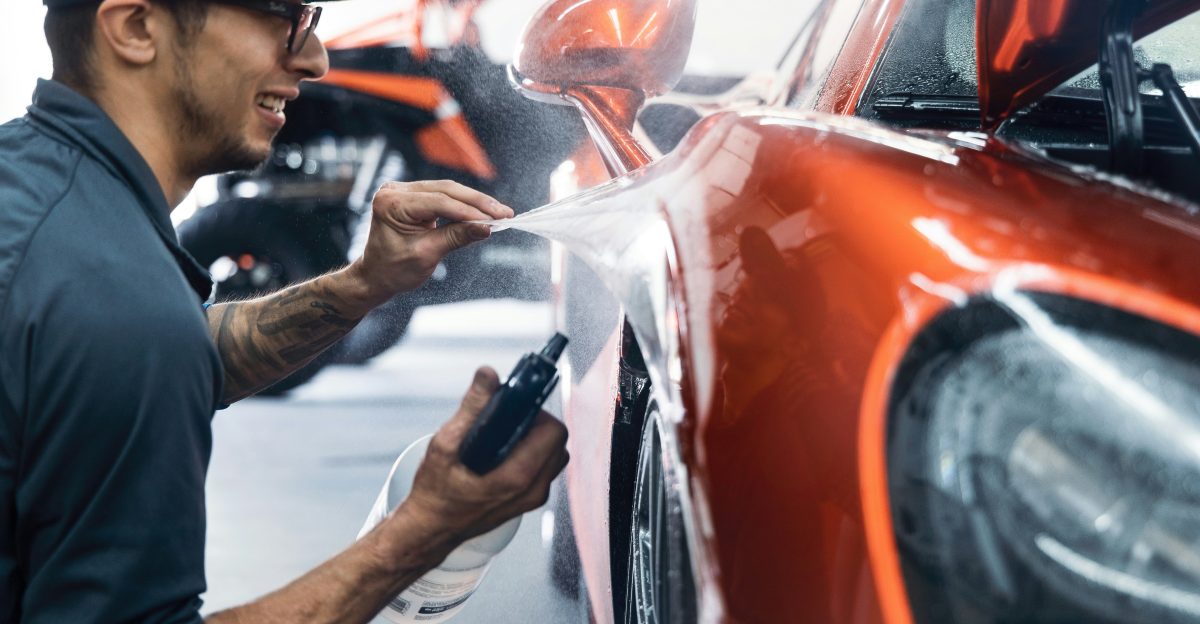 a man waxing a car in a garage
