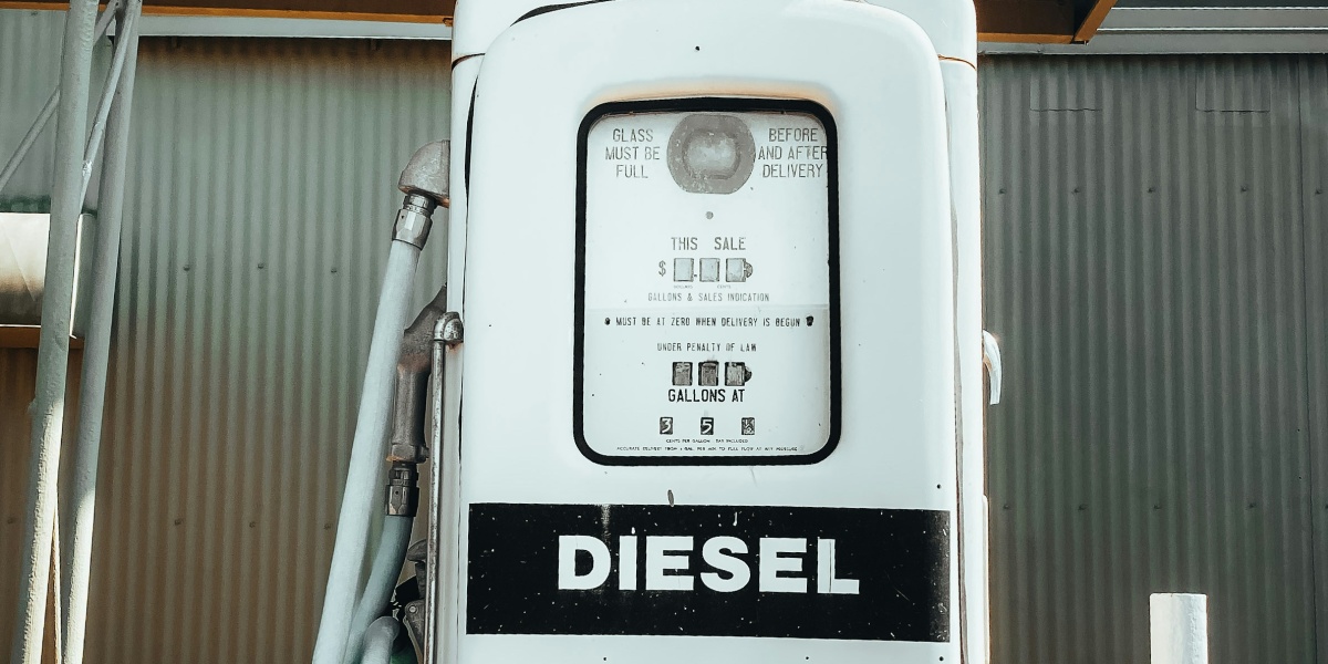 an old diesel gas pump with a hose hooked up to it