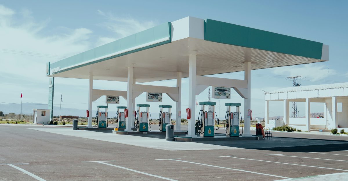 a row of gas pumps sitting in a parking lot