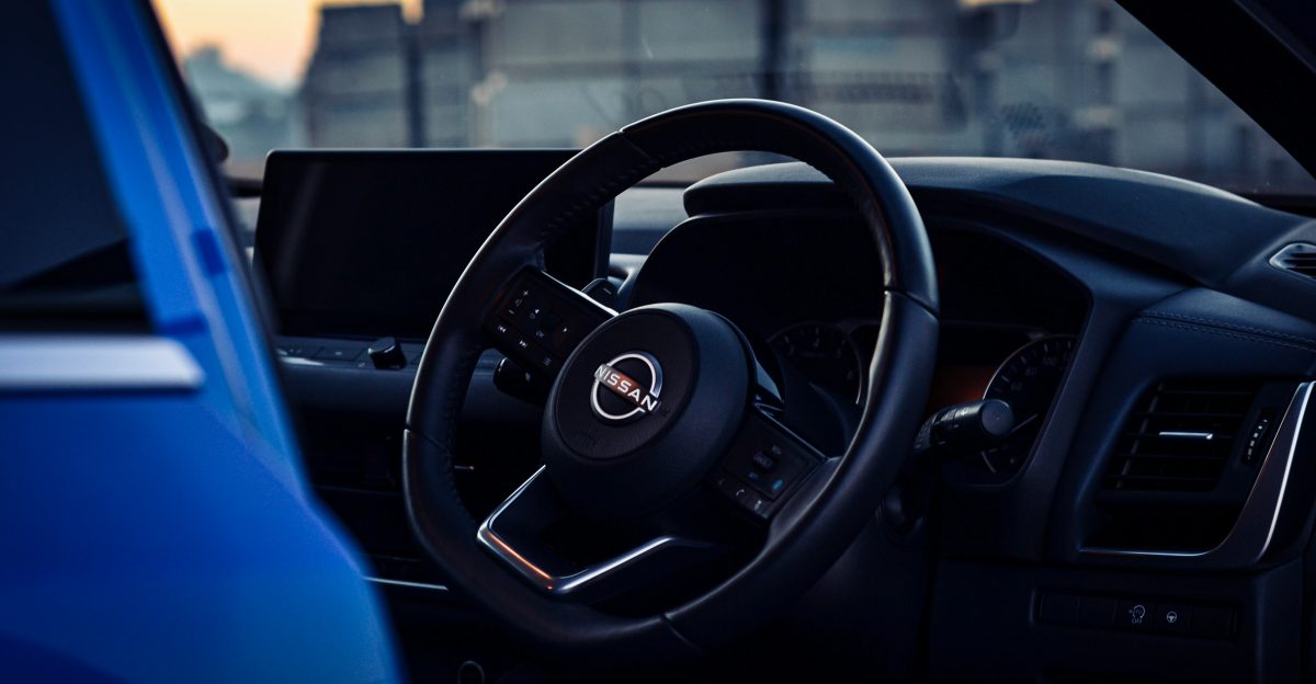 the interior of a car with a steering wheel and dashboard