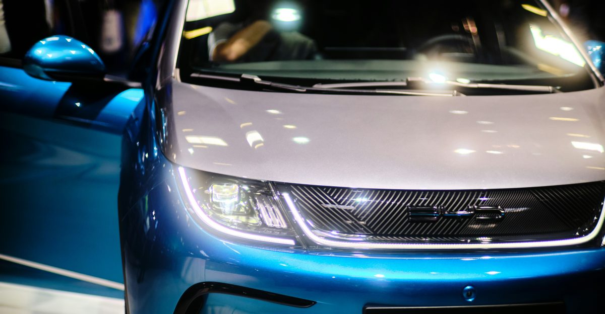 a close up of the front of a blue and white car