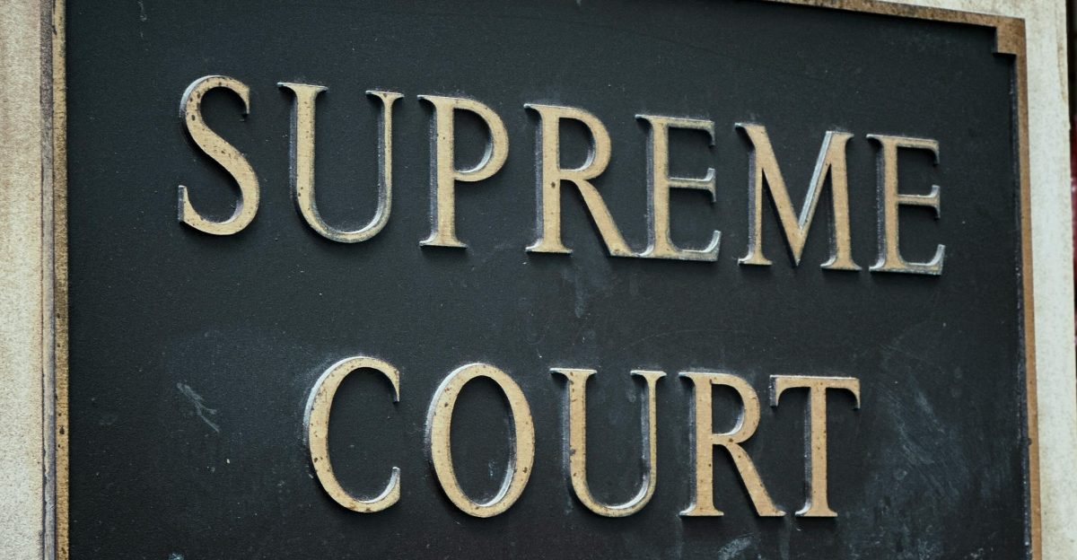 a black and gold sign that says supreme court