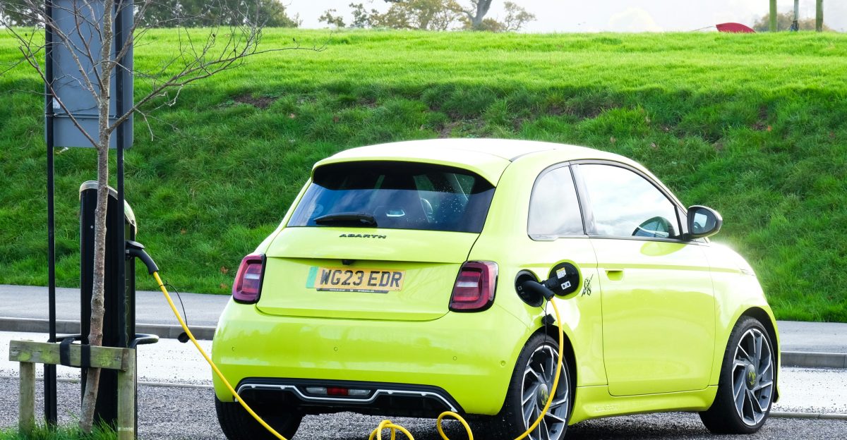 a yellow car is plugged into a charging station