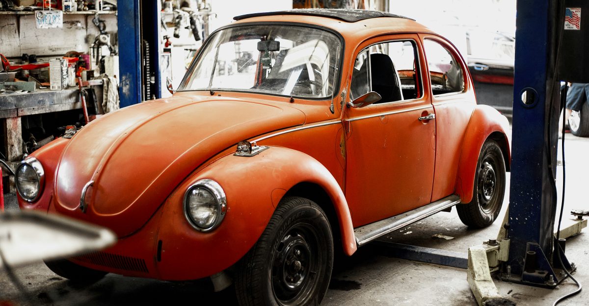 an orange car is parked in a garage