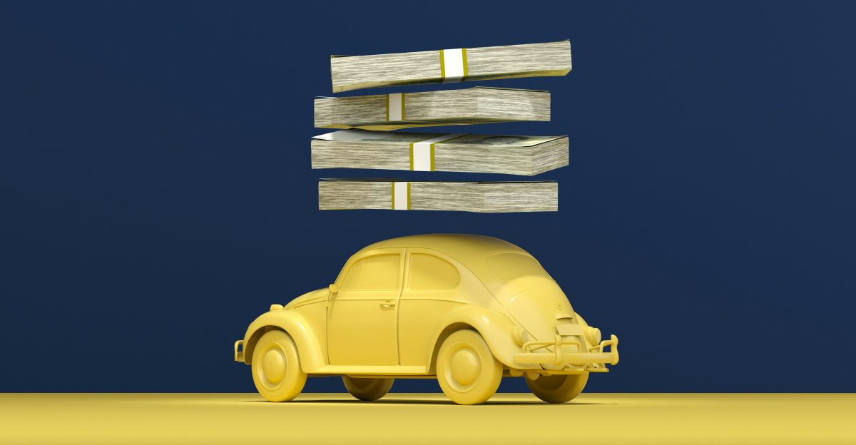 a yellow car with stacks of money on top of it