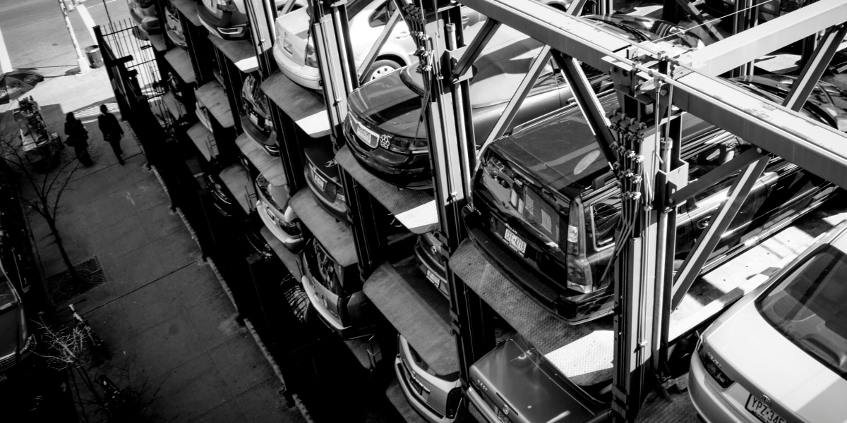 a black and white photo of cars in a parking lot