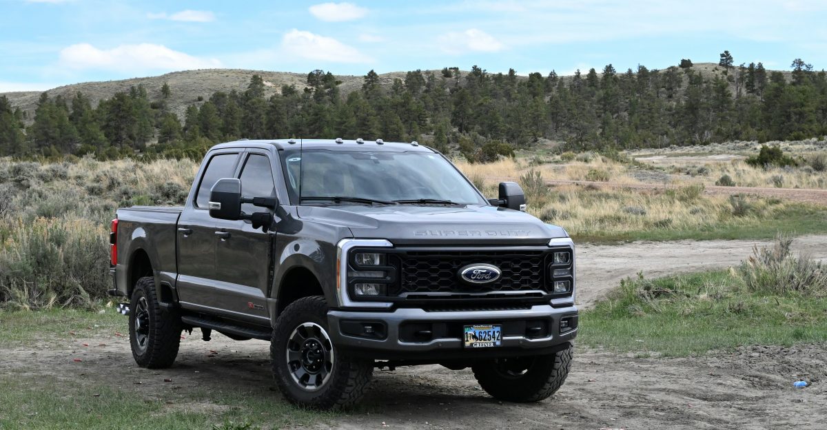 a black truck parked on a dirt road