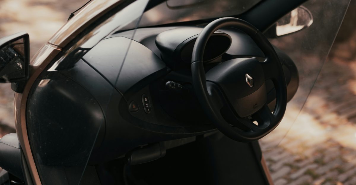 A close up of a motorcycle with a steering wheel