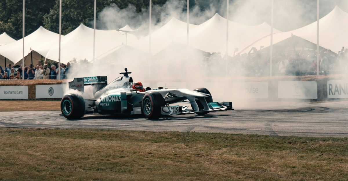 A man driving a race car on top of a race track