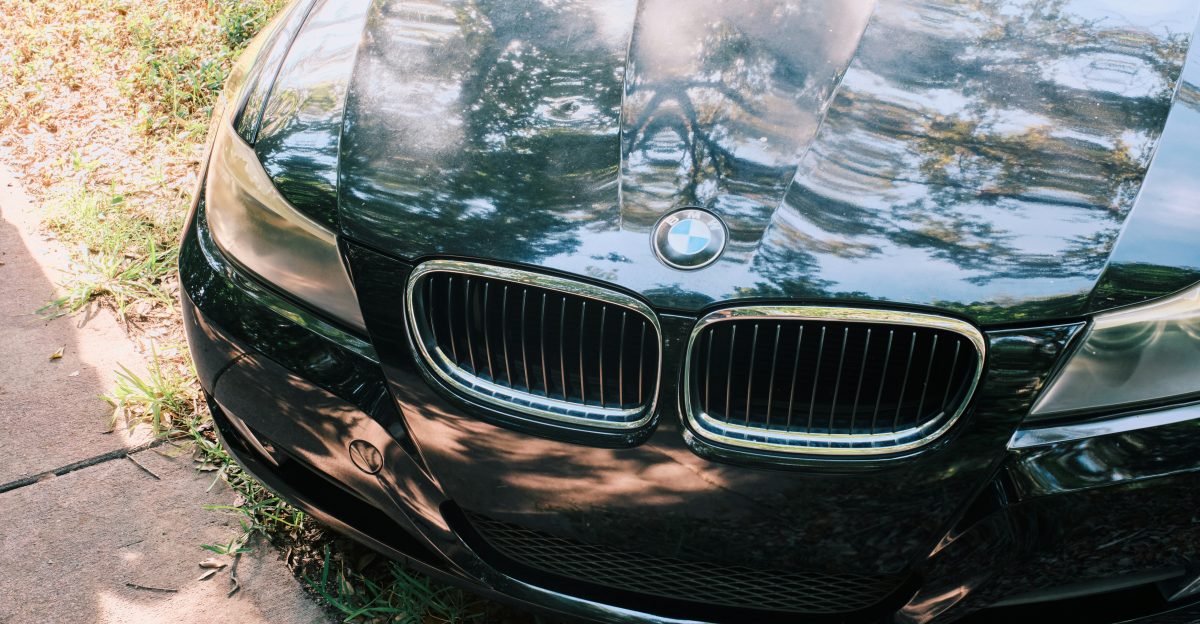 Black BMW car parked on grass