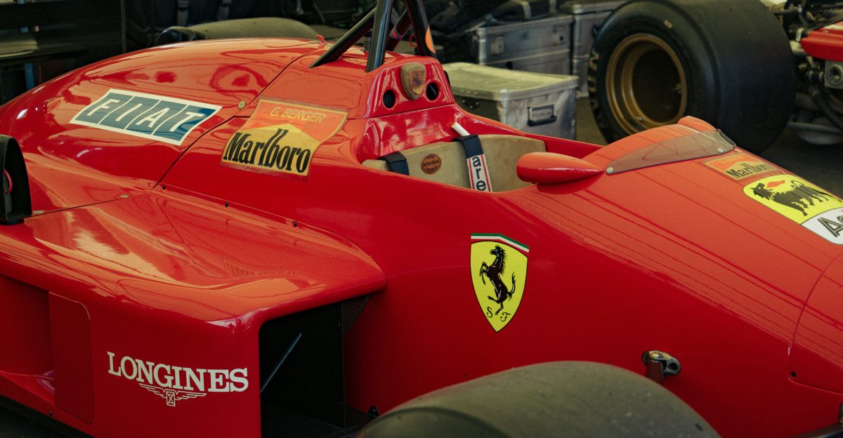 Red ferrari formula 1 car with logos