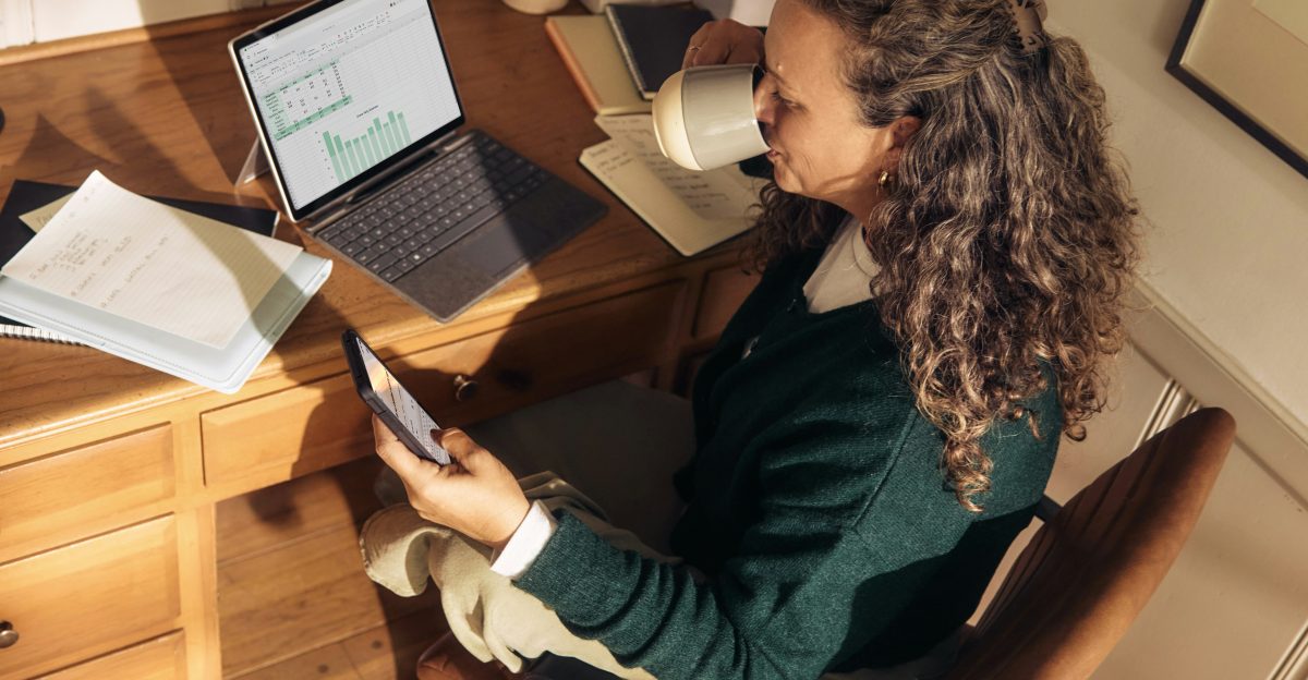 Woman working at a desk with laptop and tablet