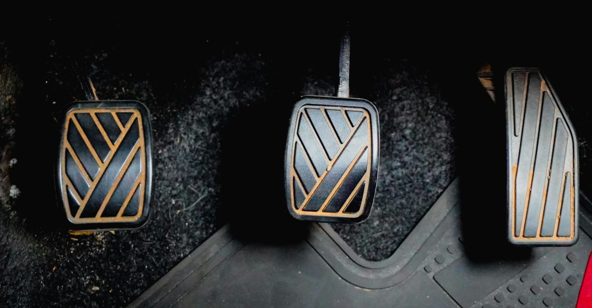 Three car pedals on the floor