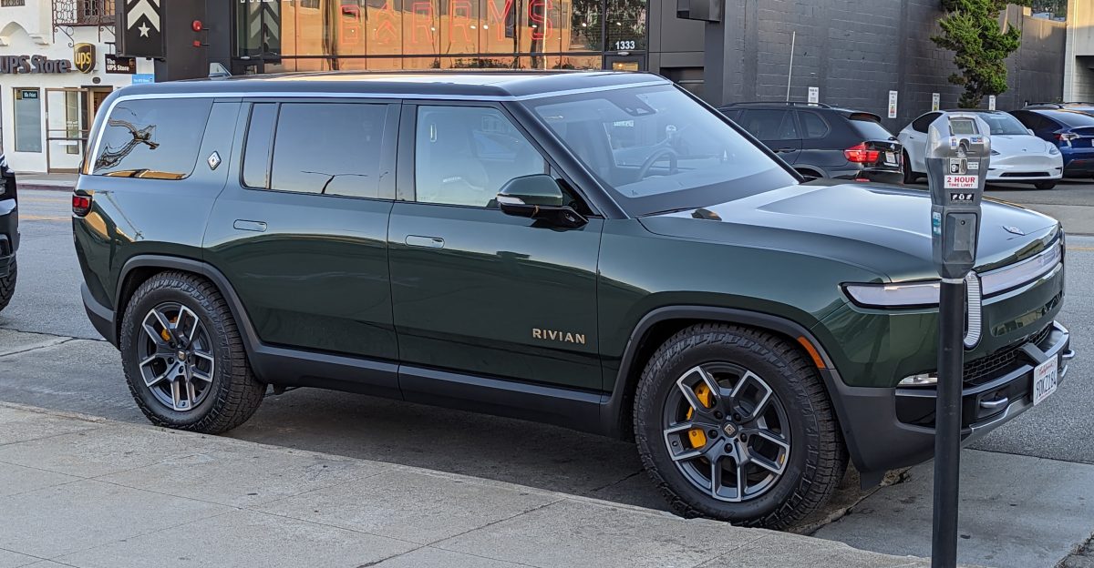 Rivian R1S sport utility vehicle in a dark green color parked on Howard Avenue in Burlingame California